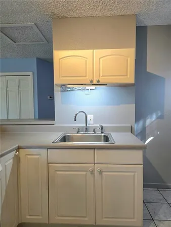 a kitchen with white cabinets and a sink