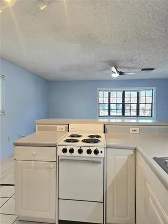 a stove top oven sitting inside of a kitchen