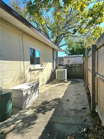 a view of a patio with table and chairs and wooden fence