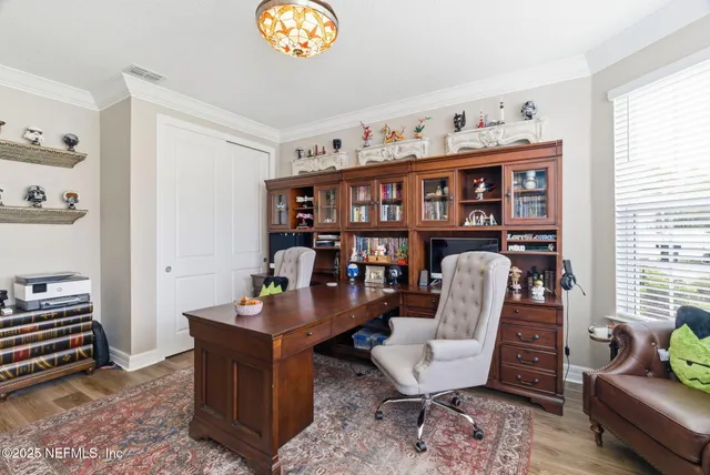 a bedroom with a bed furniture and a book shelf