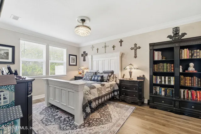 a bedroom with a bed and a chandelier