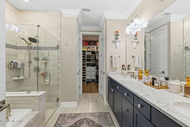 a view of walk in closet with clothes and shoes