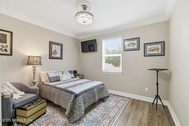 a bedroom with furniture and a flat screen tv