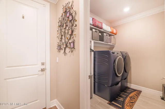 a large kitchen with stainless steel appliances kitchen island granite countertop a stove a sink dishwasher and a microwave oven with large wooden cabinets