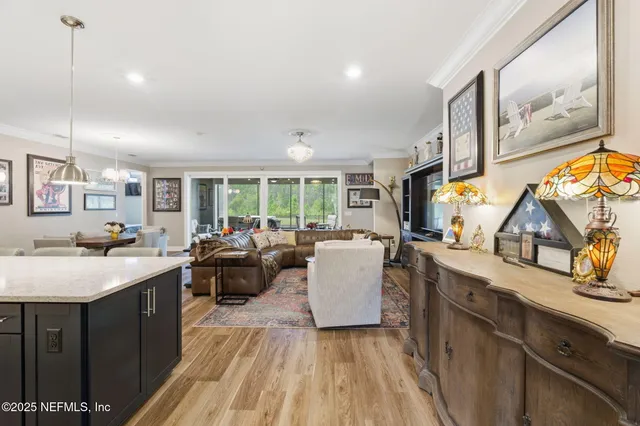 a large kitchen with kitchen island a sink counter space and living room view