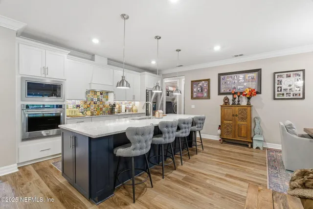 a living room with lots of furniture and kitchen view