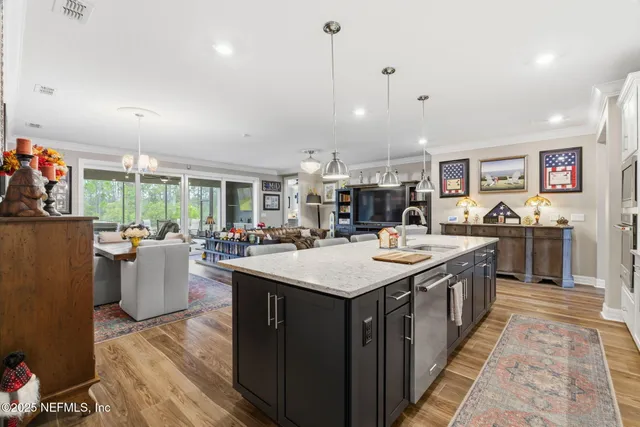 a view of staircase with lots of frames on wall and a window