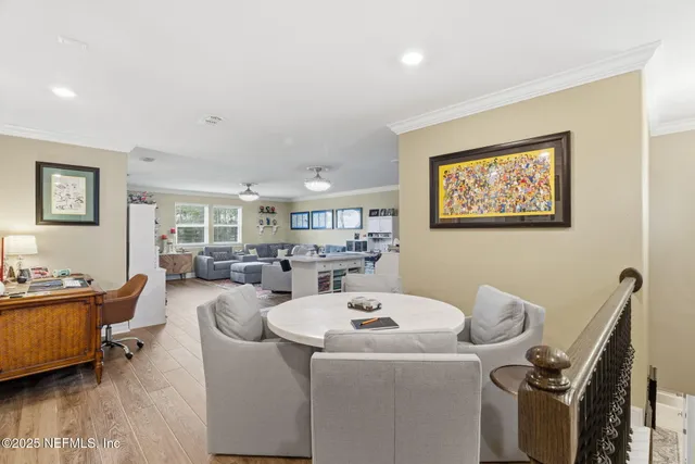 a living room with furniture and floor to ceiling windows