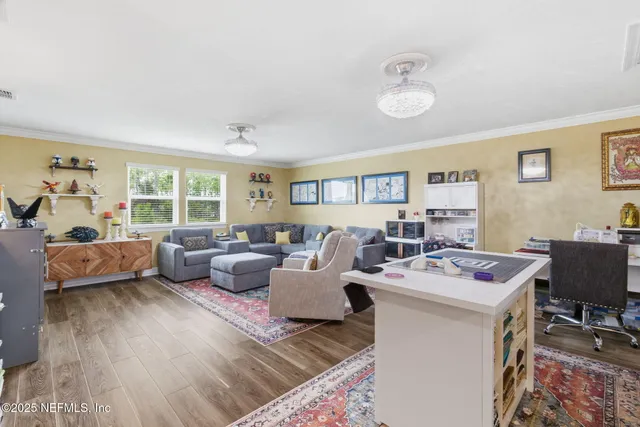 a view of a dining room with furniture large windows and wooden floor