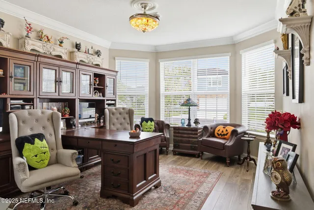 a living room with furniture and book shelf