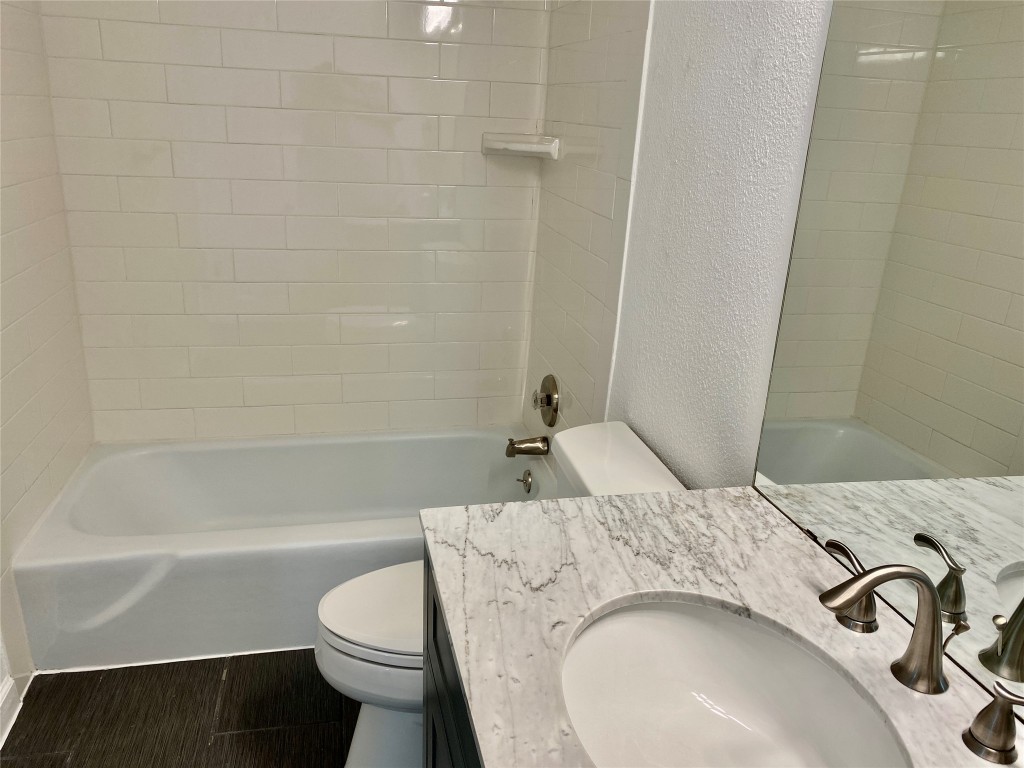 807 Blanco Street, Unit 304 Austin, TX 78703 - Photo 13 of 21 Full bathroom featuring vanity, a textured wall, and shower combination