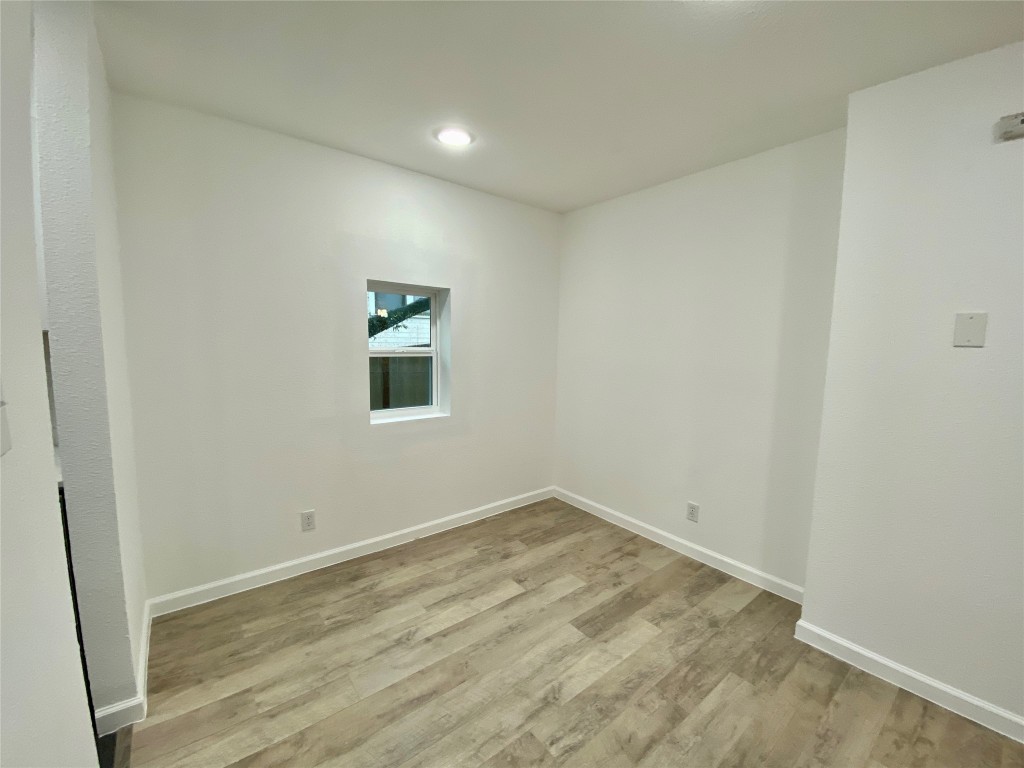 807 Blanco Street, Unit 304 Austin, TX 78703 - Photo 6 of 21 Unfurnished room with light wood-style flooring and recessed lighting