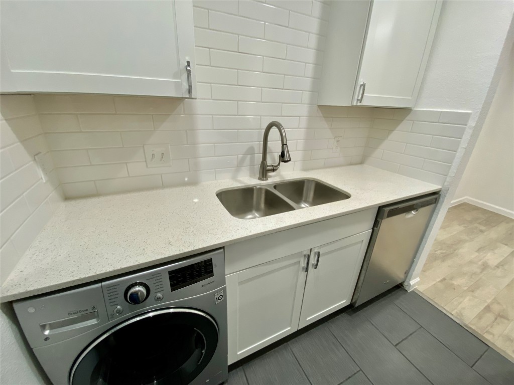807 Blanco Street, Unit 304 Austin, TX 78703 - Photo 10 of 21 Laundry room featuring washer / clothes dryer and dark wood-type flooring