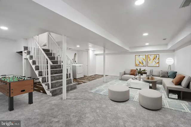 a living room with furniture gym equipment and white walls