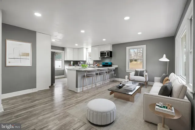 a living room with furniture and kitchen view