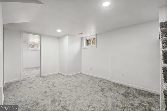 a front view of house with yard and trees around