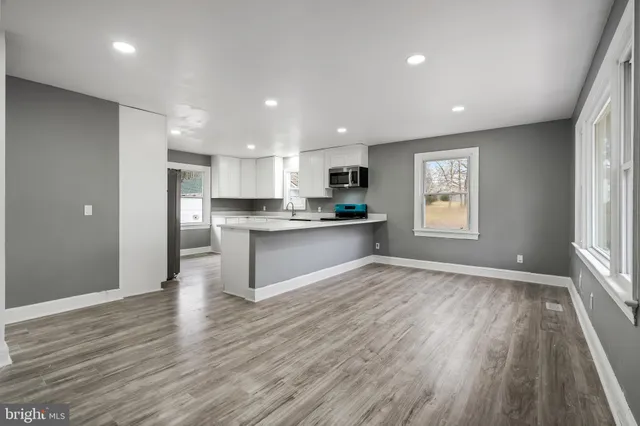 a view of kitchen with wooden floor and windows