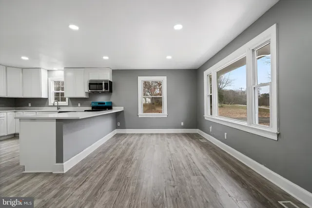a kitchen with a refrigerator and a stove top oven