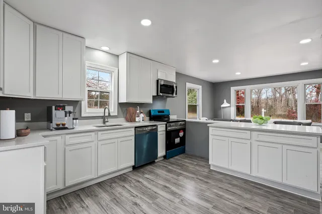 a kitchen with a sink cabinets and window