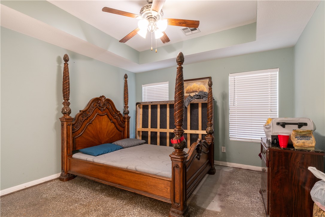 202 Eagle Point Court Waco, TX 76705 - Photo 12 of 14 a bedroom with bed and a chandelier