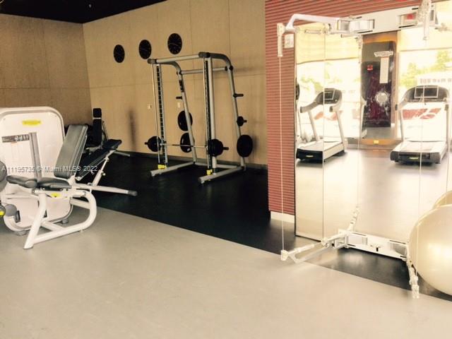 2602 East Hallandale Beach Boulevard, Unit R407 Hallandale Beach, FL 33009 - Photo 13 of 39 a room with gym equipment and a large window