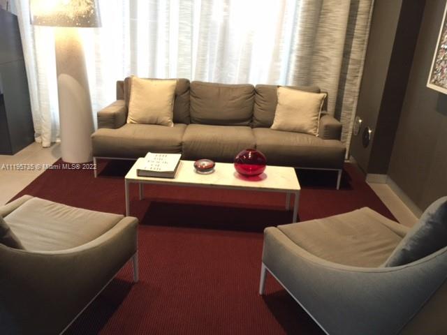2602 East Hallandale Beach Boulevard, Unit R407 Hallandale Beach, FL 33009 - Photo 15 of 39 a living room with furniture and a couch