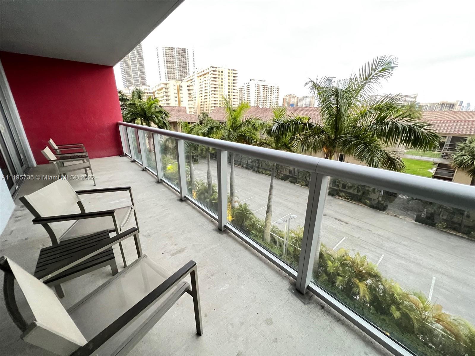2602 East Hallandale Beach Boulevard, Unit R407 Hallandale Beach, FL 33009 - Photo 18 of 39 a view of a balcony with chairs