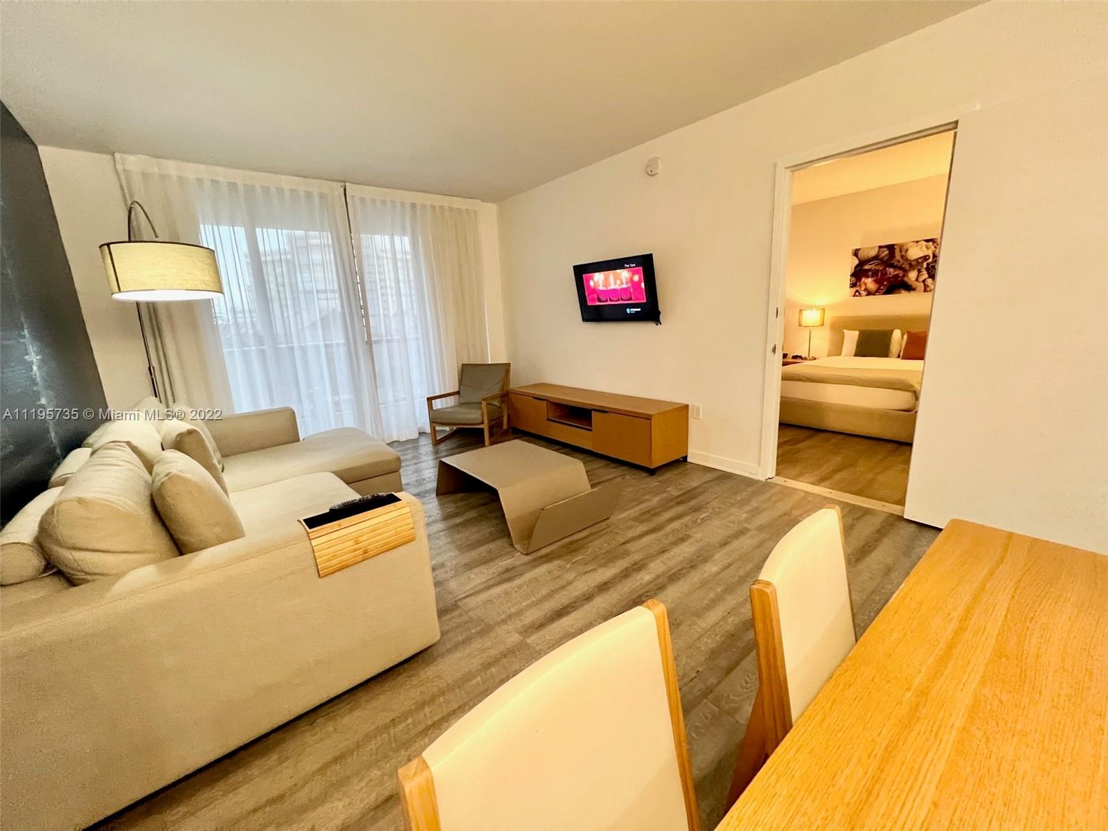 2602 East Hallandale Beach Boulevard, Unit R407 Hallandale Beach, FL 33009 - Photo 24 of 39 a bed room with a bed and a couch