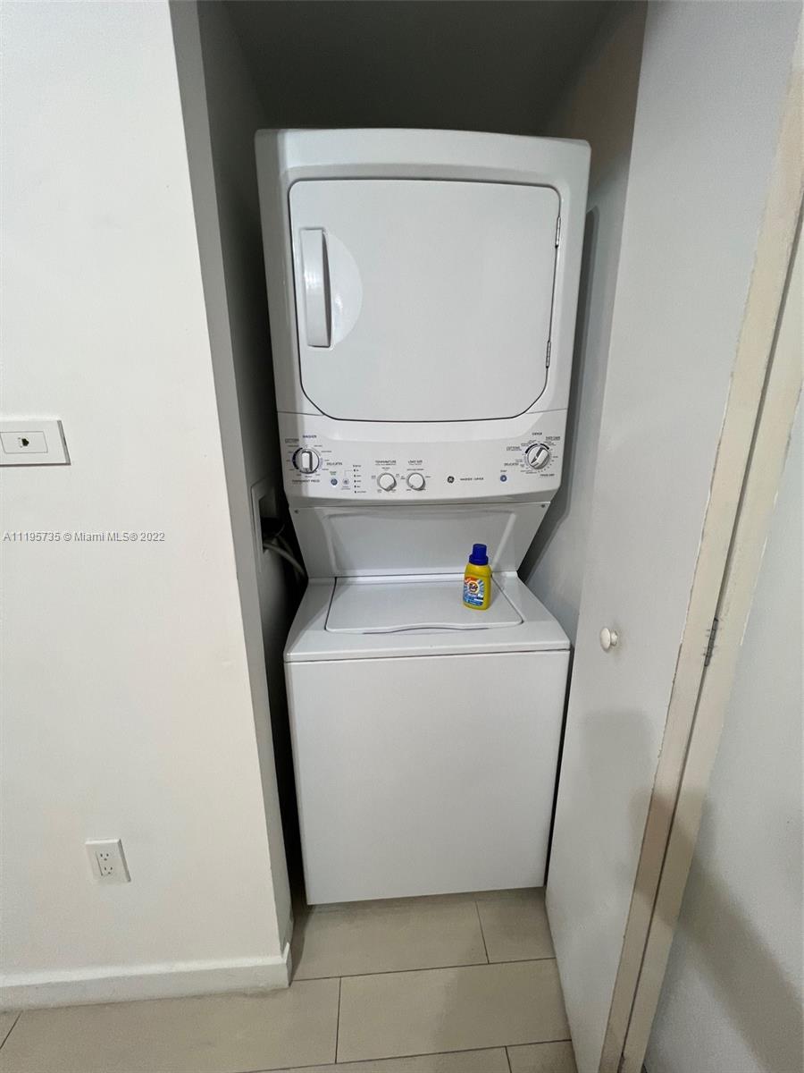 2602 East Hallandale Beach Boulevard, Unit R407 Hallandale Beach, FL 33009 - Photo 36 of 39 a utility room with dryer and washer