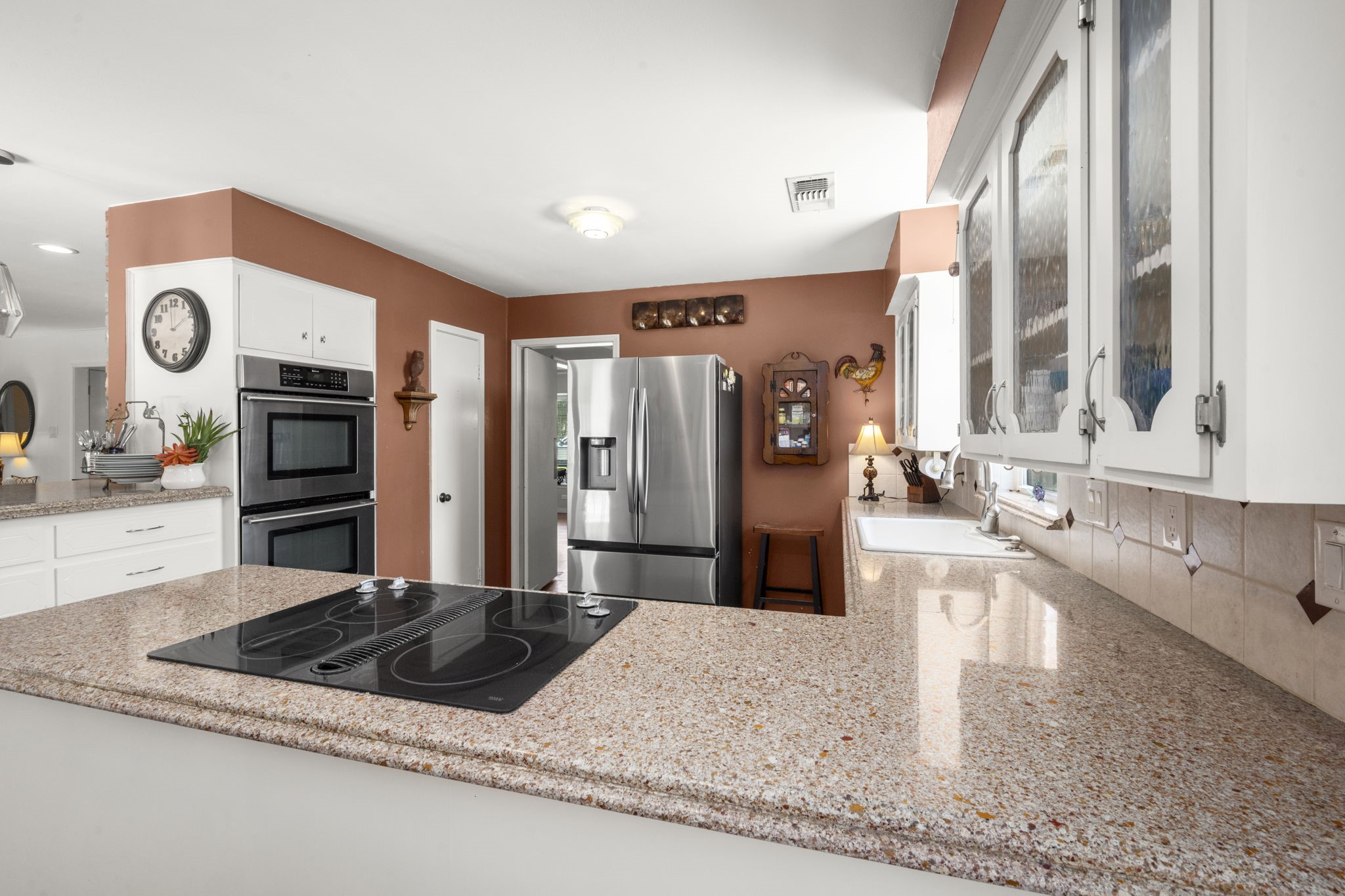 2506 Teague Road Houston, TX 77080 - Photo 20 of 33 a kitchen with stainless steel appliances granite countertop a refrigerator a oven and white cabinets with wooden floor