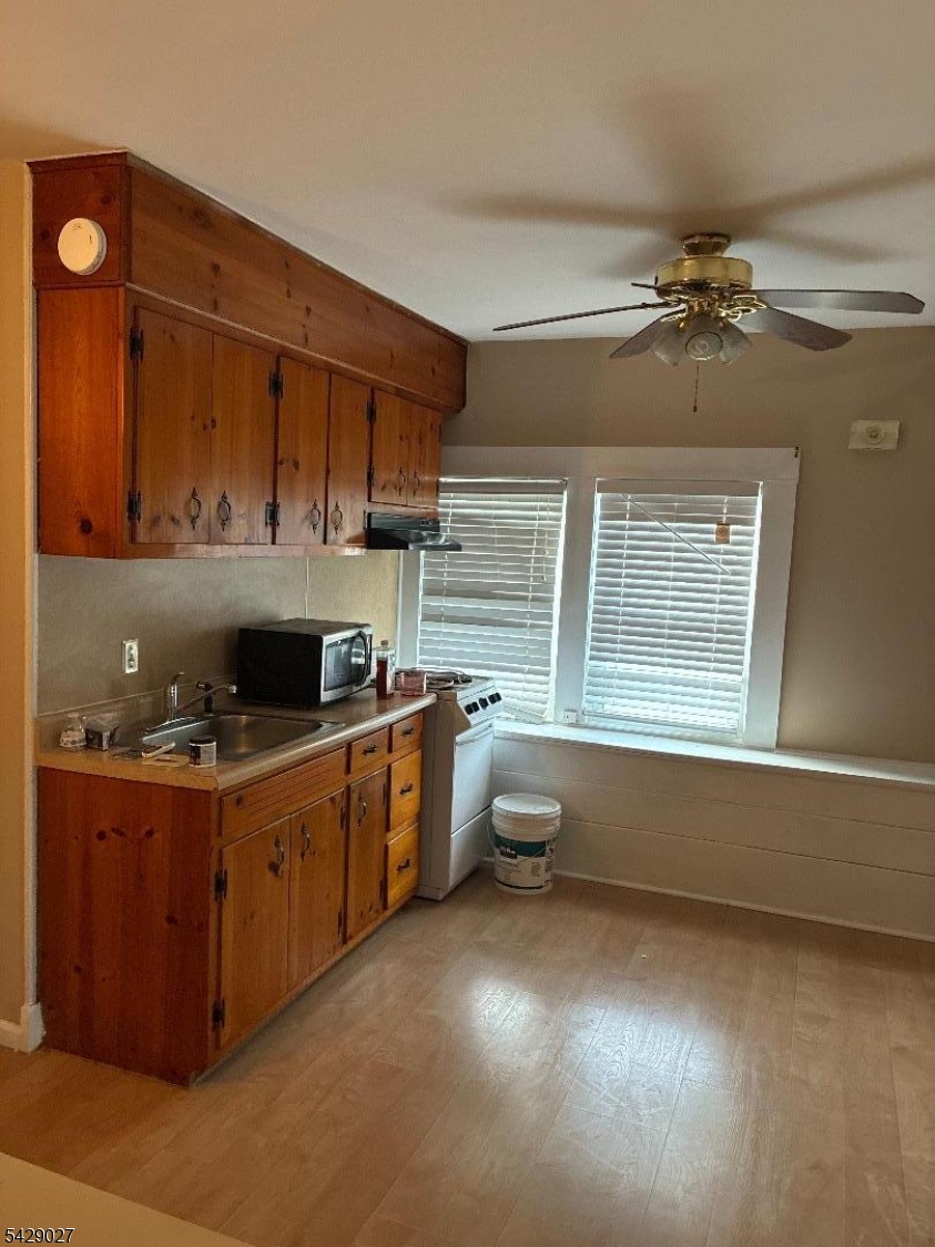 305 Penfield Place Dunellen, NJ 08812 - Photo 3 of 11 a kitchen with granite countertop a stove and a sink