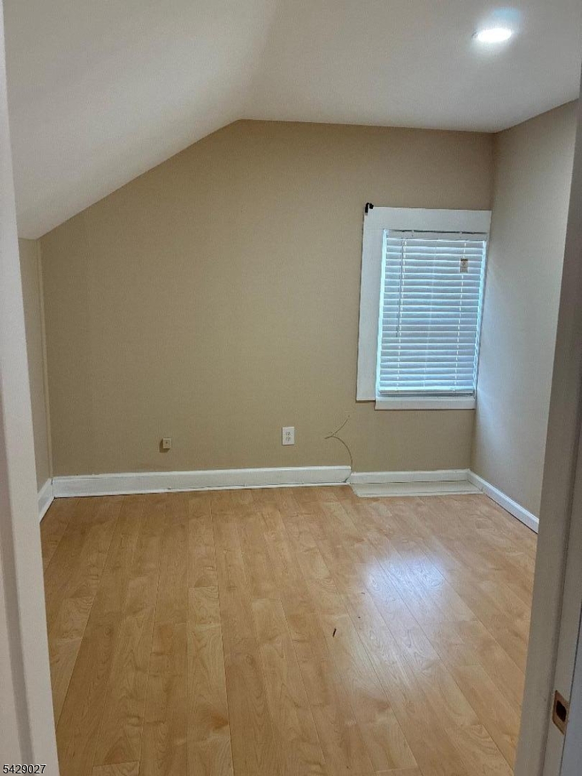 305 Penfield Place Dunellen, NJ 08812 - Photo 4 of 11 an empty room with a workbench