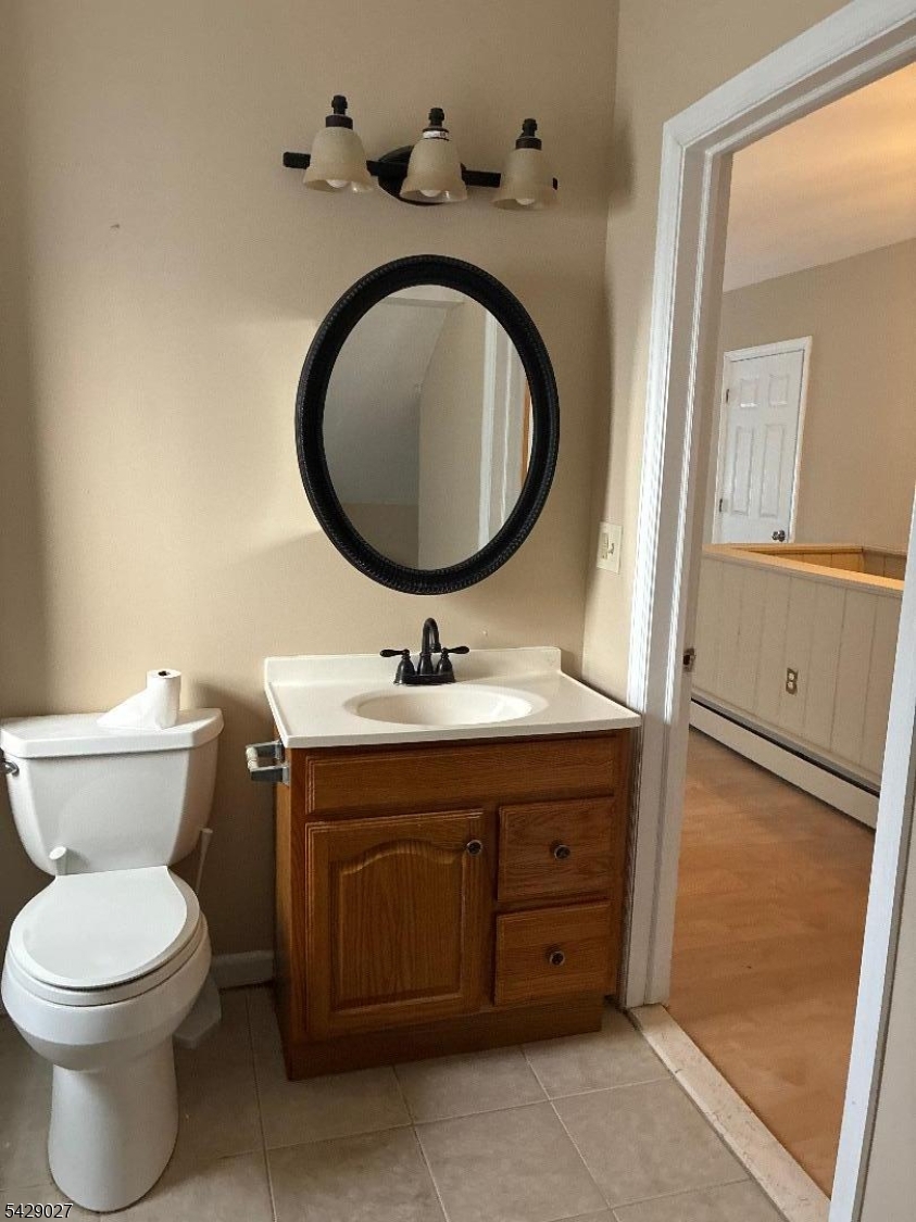 305 Penfield Place Dunellen, NJ 08812 - Photo 5 of 11 a bathroom with a toilet sink and mirror
