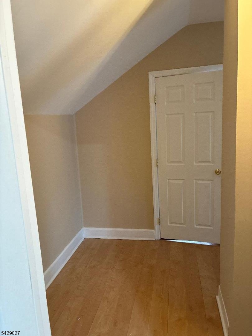 305 Penfield Place Dunellen, NJ 08812 - Photo 8 of 11 an empty room with a wooden door