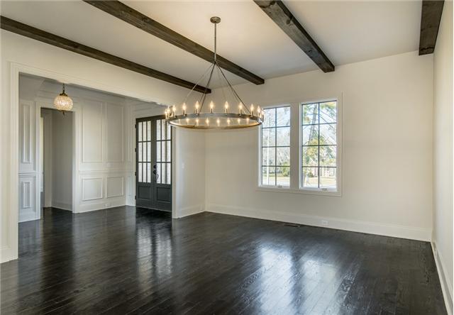 155 Cheek Road Nashville, TN 37205 - Photo 2 of 20 Grand Lighting and a rustic beam ceiling compliment this large dining room