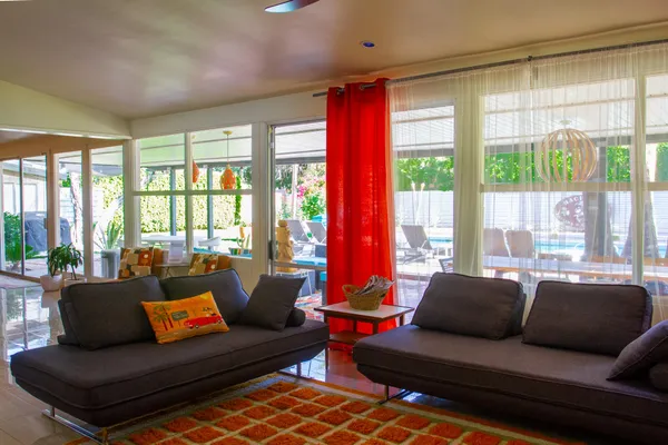 a living room with furniture and large windows