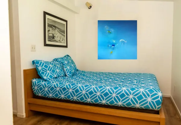 a bed sitting in a bedroom next to a window