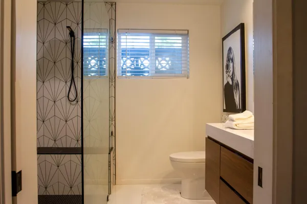 a bathroom with a toilet sink vanity and mirror