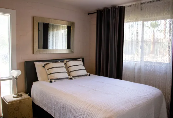 a bedroom with a bed and a window