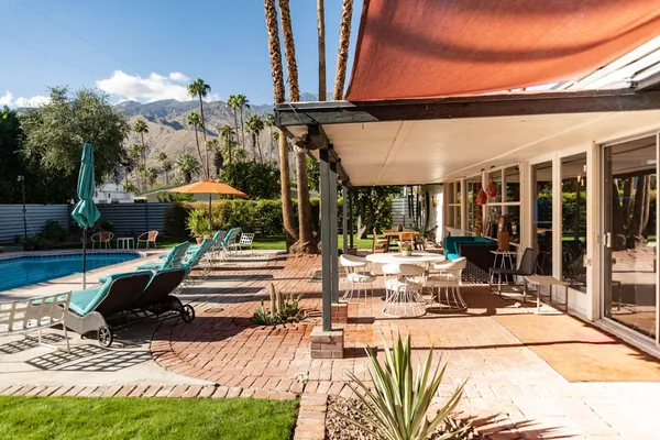 a view of a patio with swimming pool table and chairs