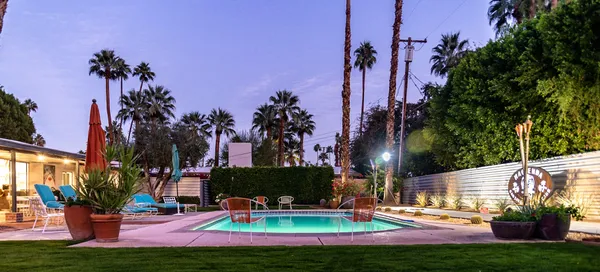 a view of a backyard with swimming pool
