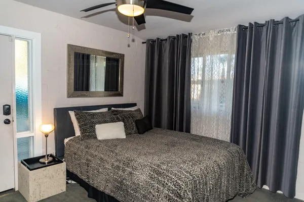 a bedroom with a bed and a chandelier