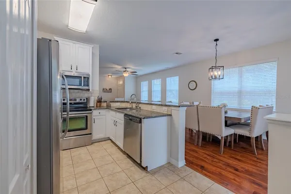 a kitchen with a stove and chairs