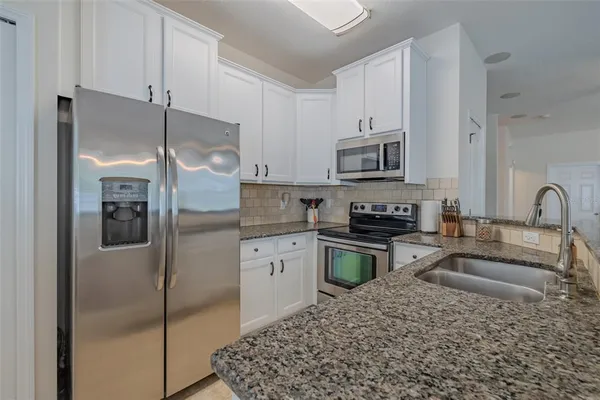 a kitchen with a refrigerator stove and sink