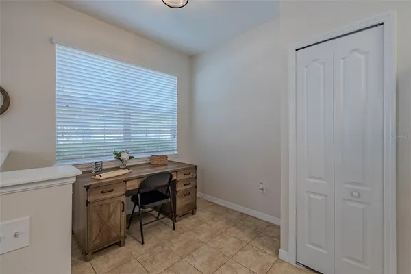 a view of a workspace with furniture and a window