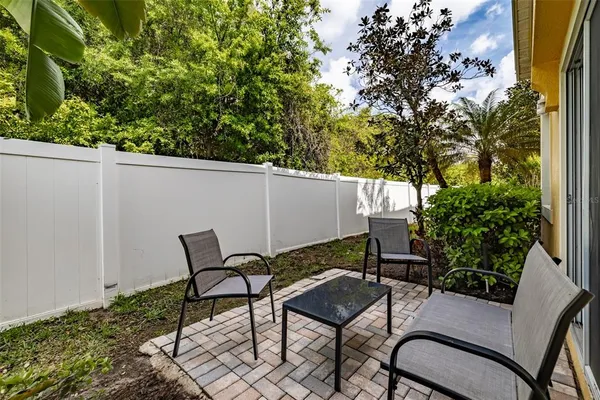 a view of a patio with table and chairs and potted plants