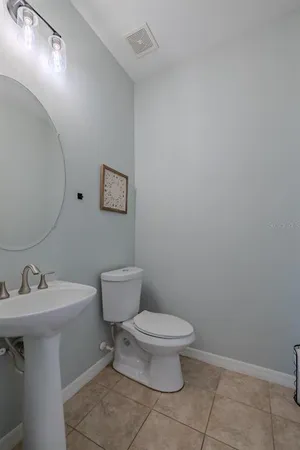 a white toilet sitting next to a bathroom sink