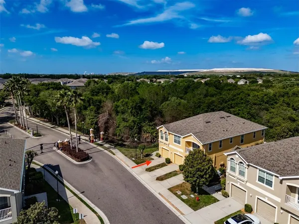 an aerial view of a house with garden space and ocean view
