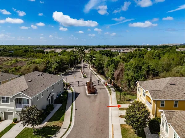 an aerial view of a house with a yard