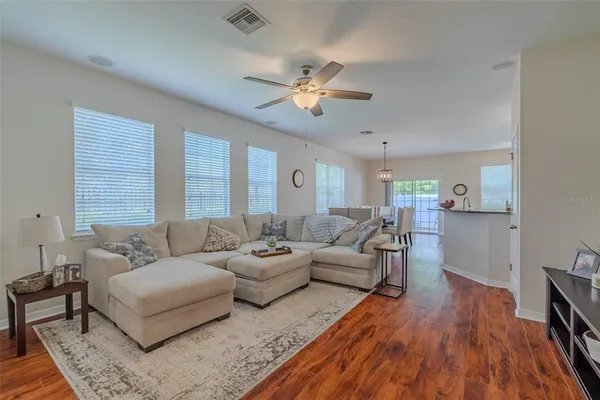 a living room with furniture and a wooden floor